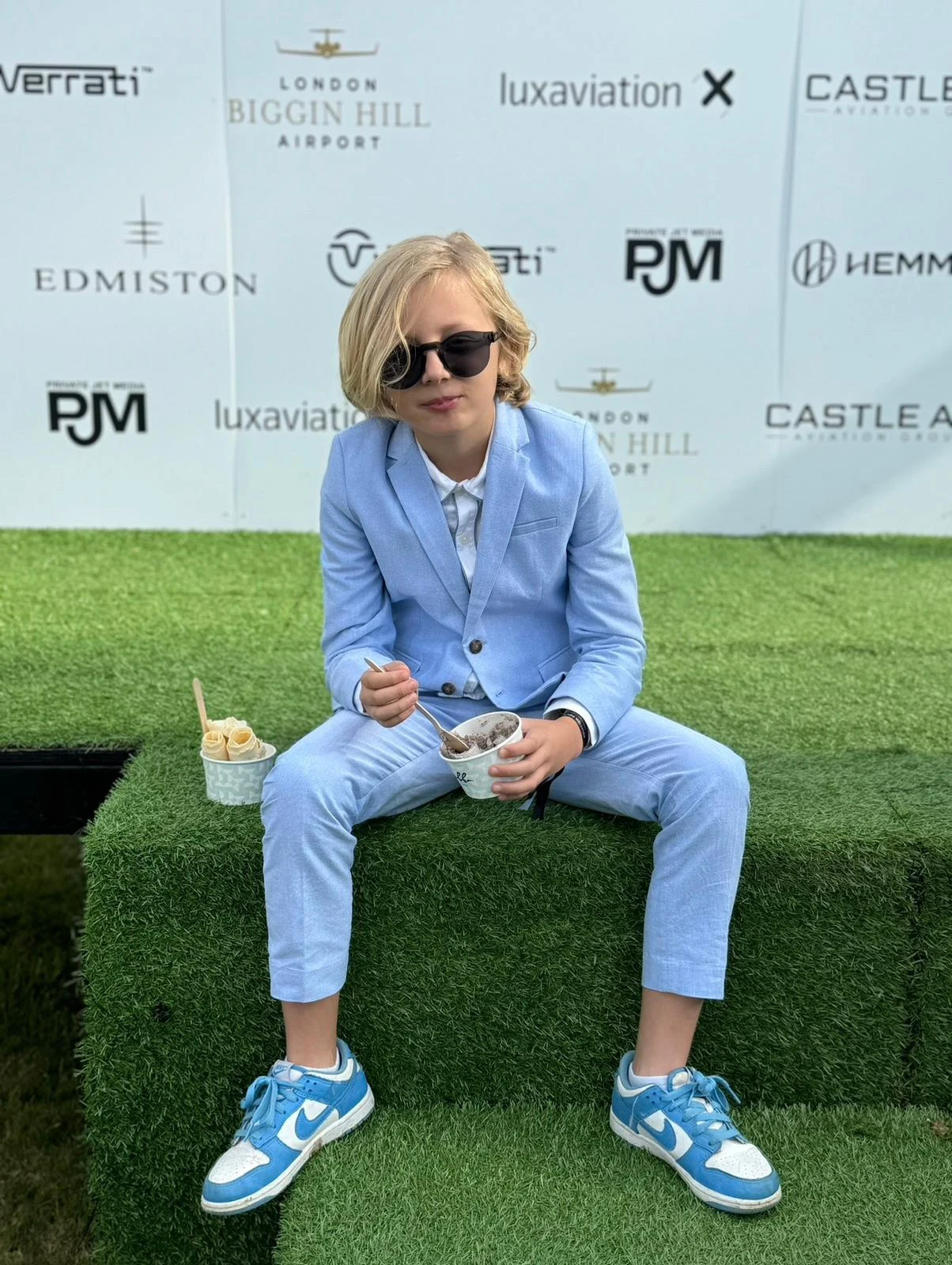 Rocco in a blue suit and sunglasses at an event